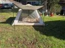 4 person camping tent front view with extended awning and large mesh entry door