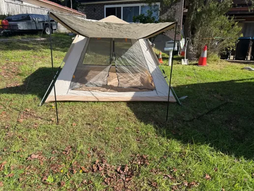4 person camping tent front view with extended awning and large mesh entry door