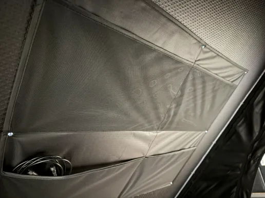 Hard shell rooftop tent interior roof lining with storage pockets